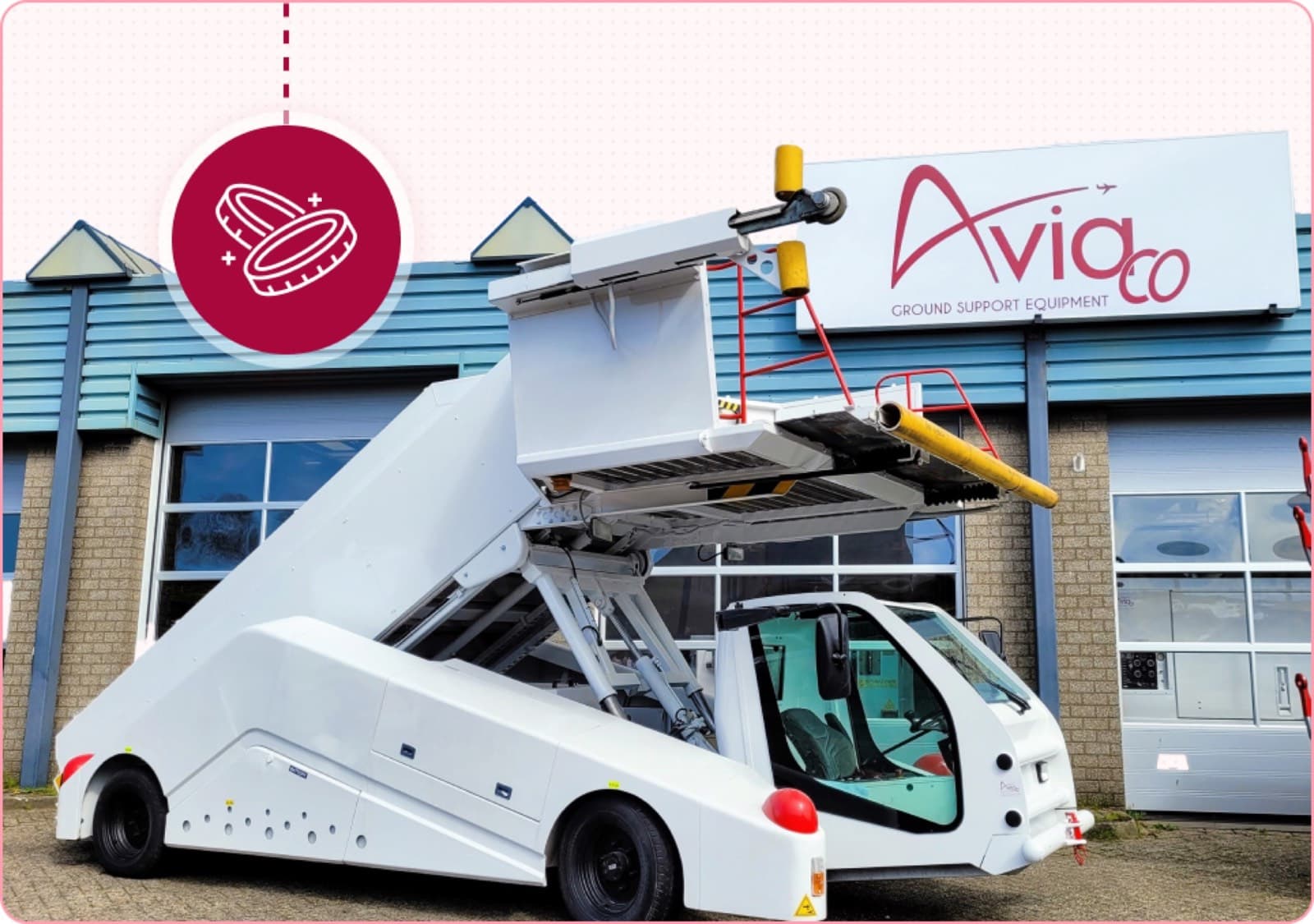 White aircraft passenger stair truck in front of Aviaco GSE building